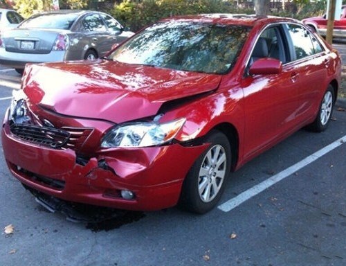 Before: red sedan front-end collision repair