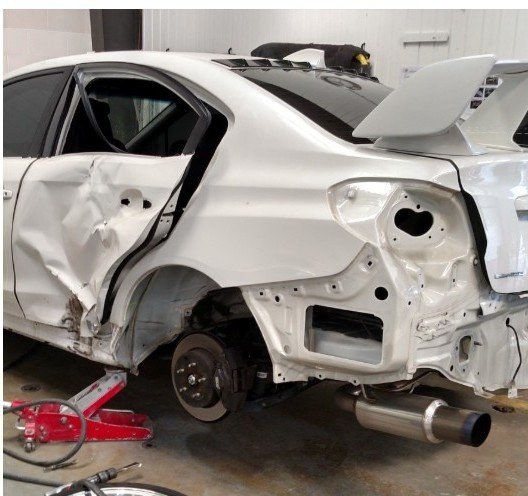 Before: white sports sedan collision repair